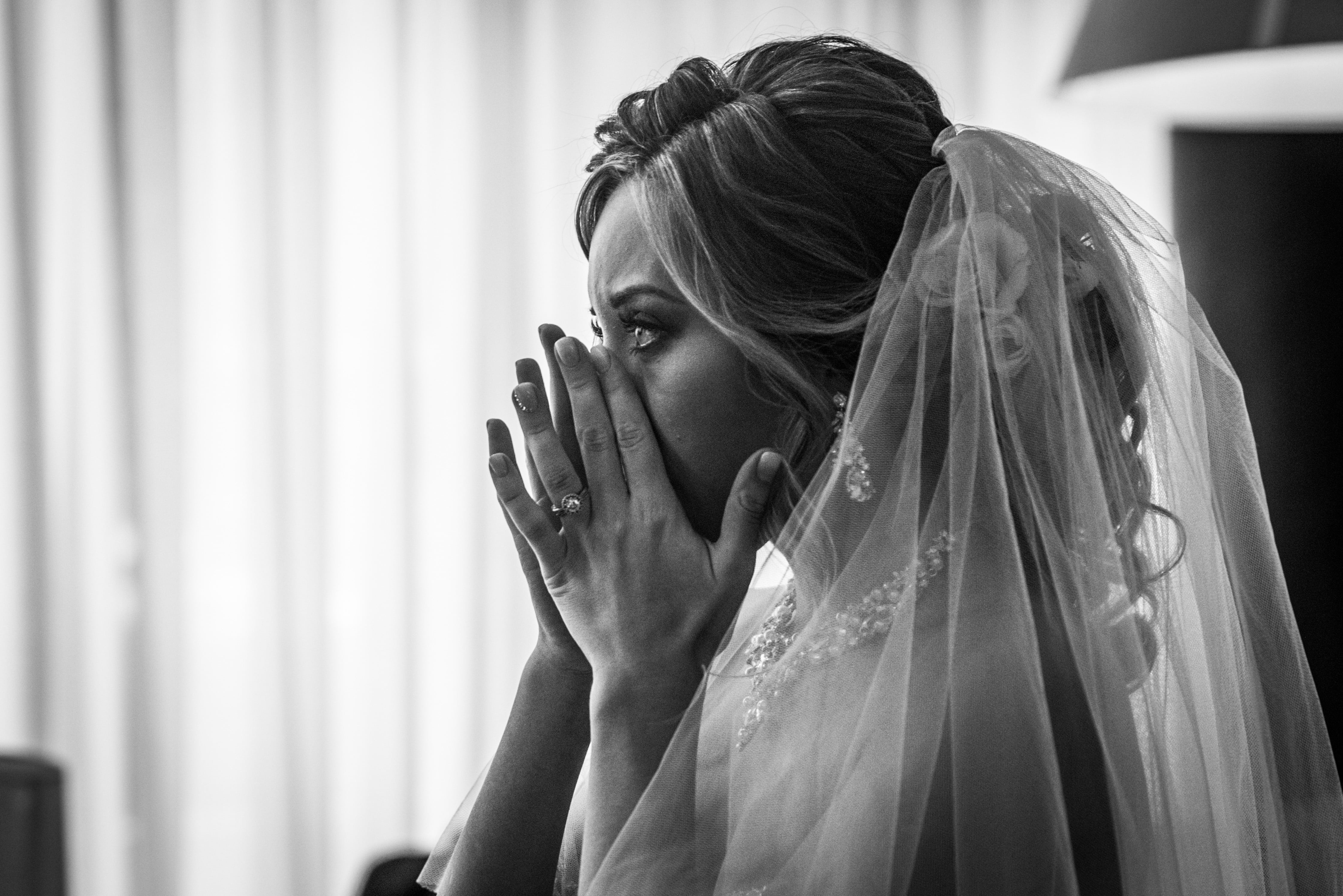 black and white picture of woman crying at wedding