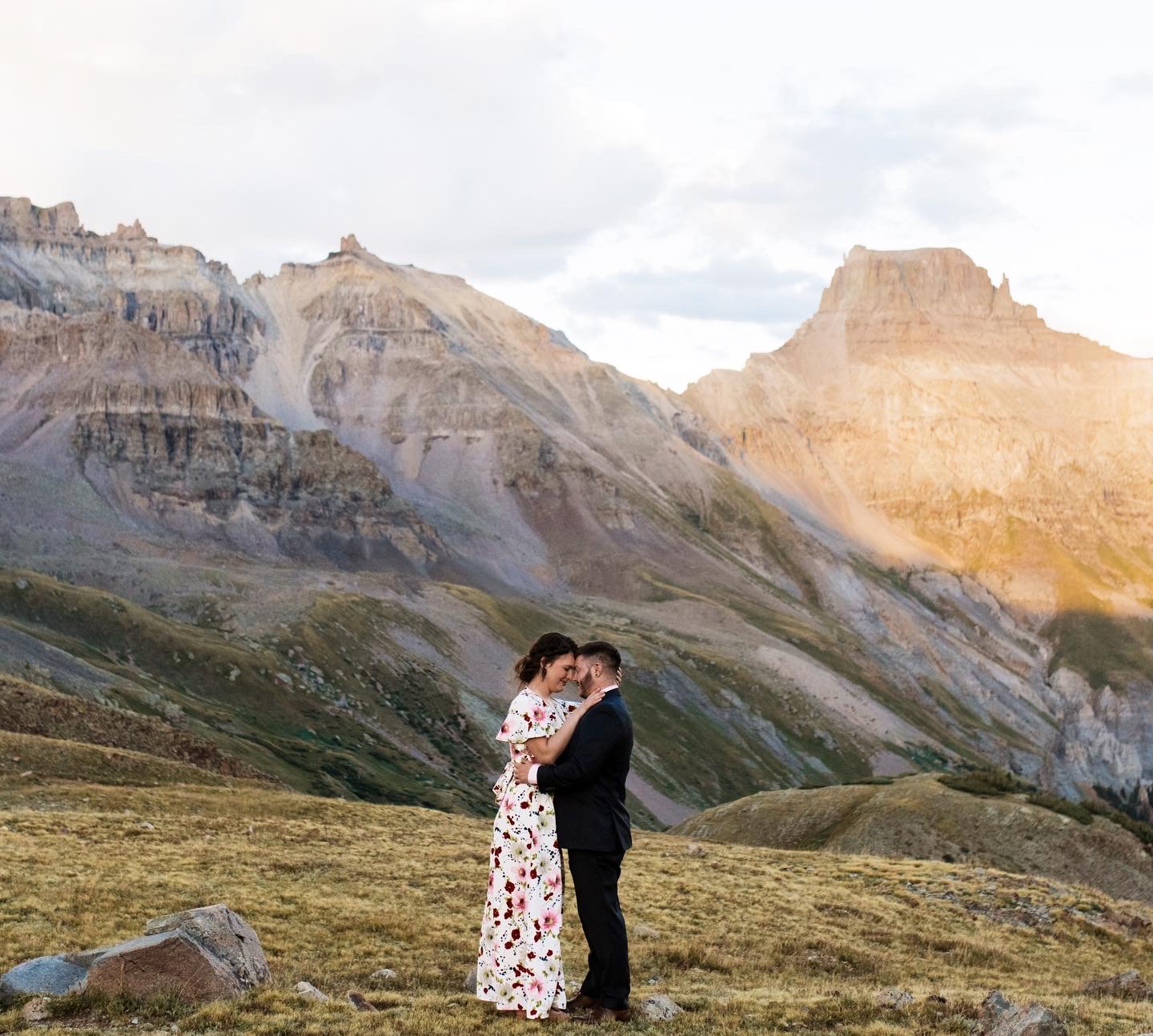 couple embracing with mountain landscape in the background