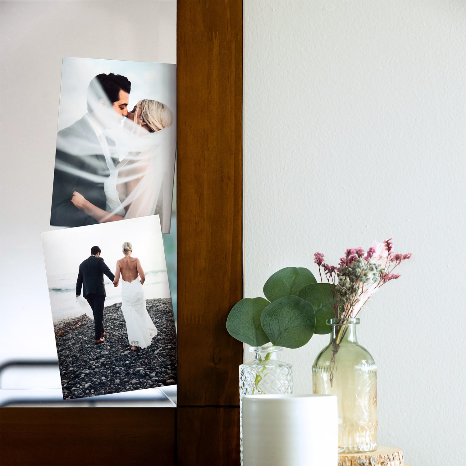 photo prints on dresser of couples wedding photos