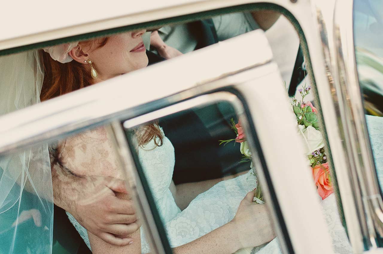 Bride and Groom getting out of wedding car